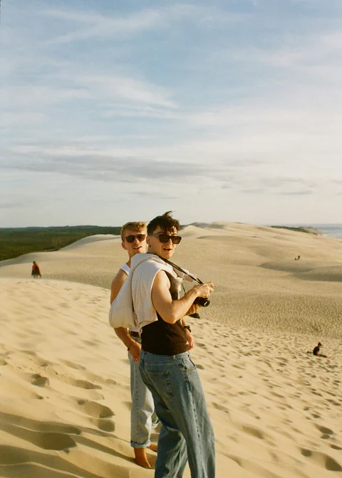 Friends sharing a memory in the sand dunes