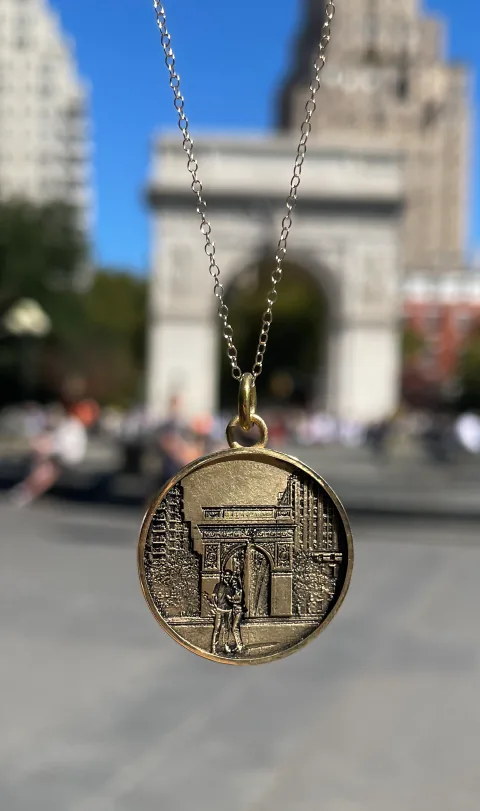 Washington Square Arch pendant photographed in the park