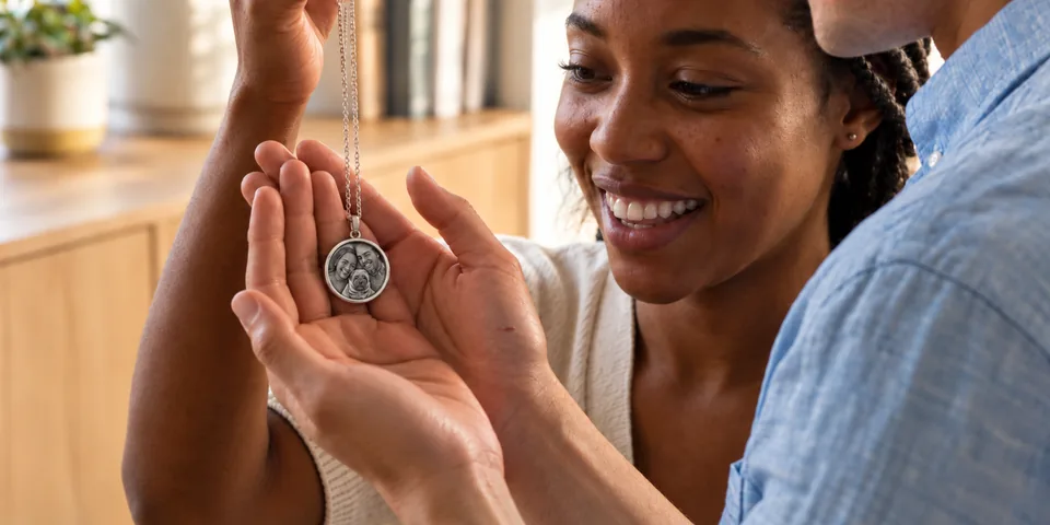 A couple admiring a custom photo pendant together