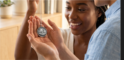 A customer holding a finished Momenza pendant