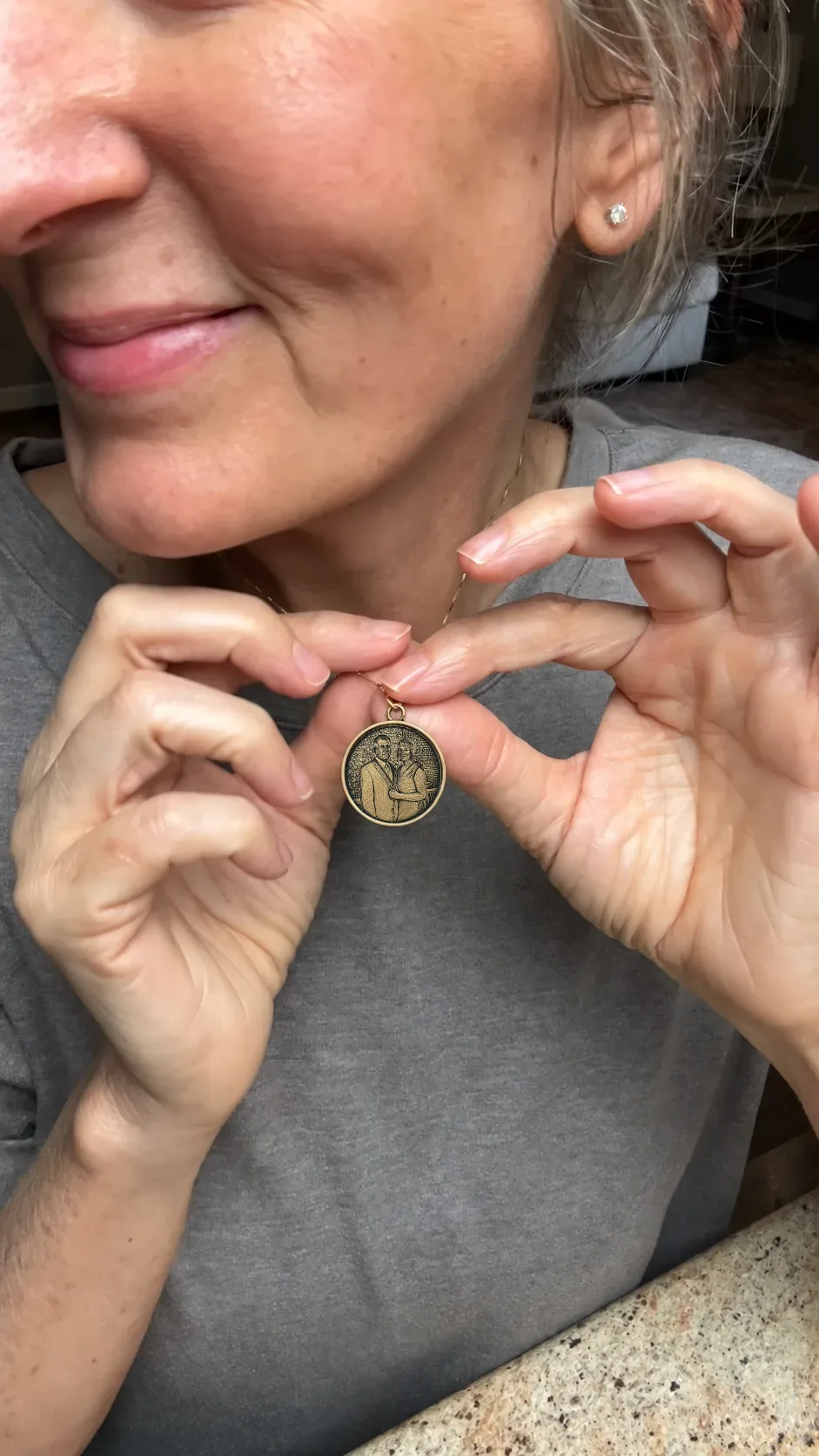 A customer holding a Momenza anniversary pendant